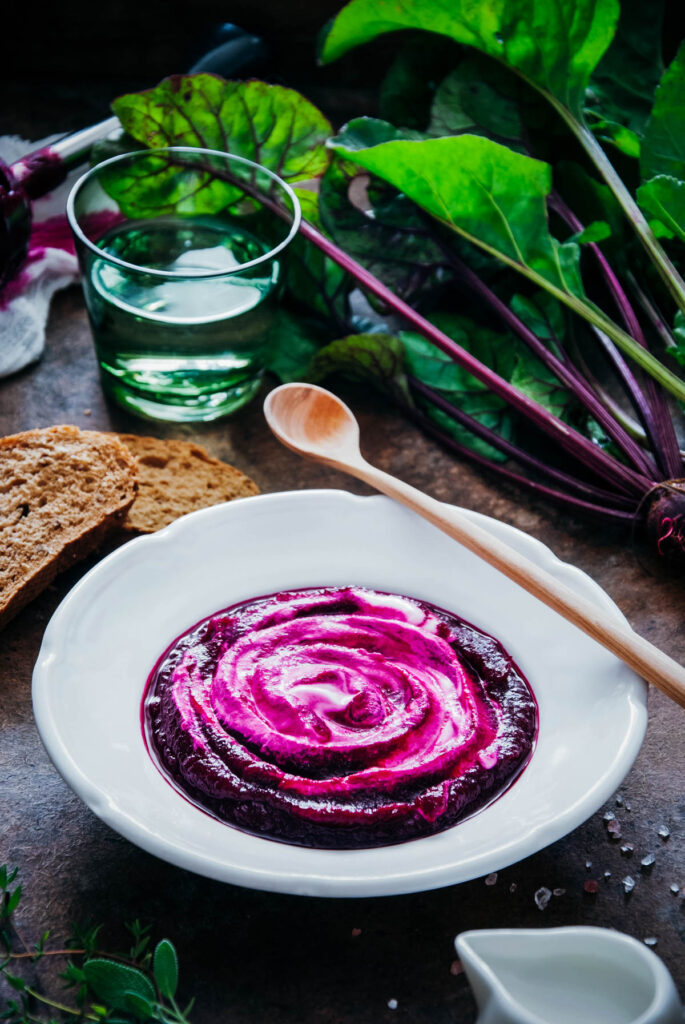 A bowl of beetroot soup on a table.