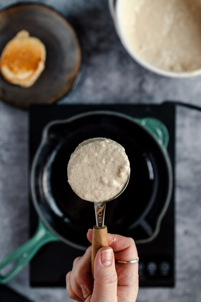 Pouring batter into a hot pan to make a pancake.
