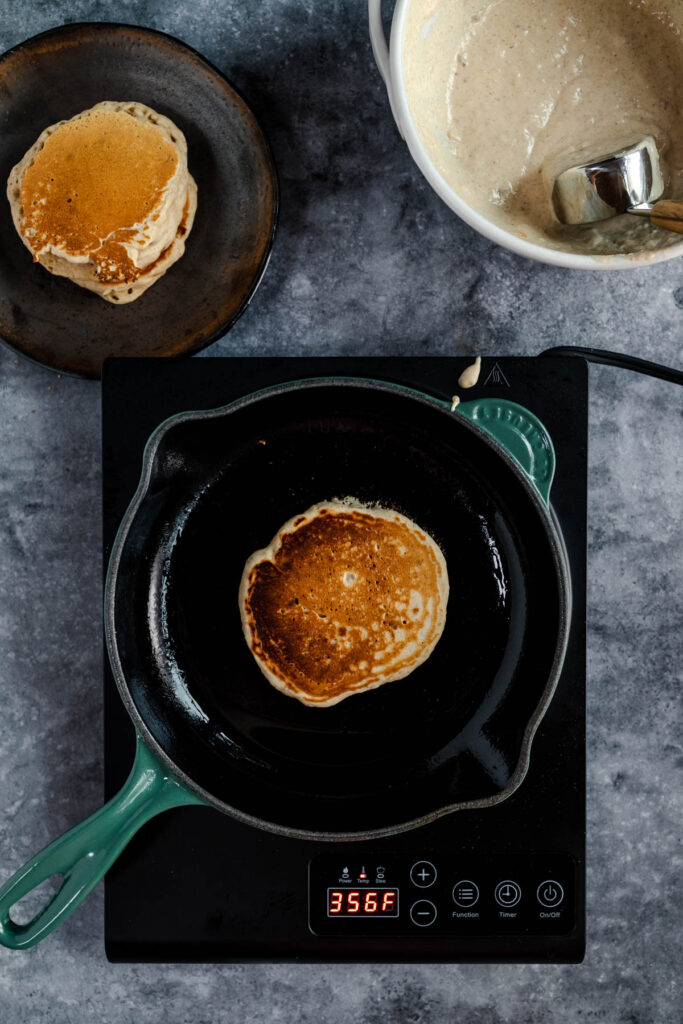 Cooking pancakes on a modern induction stove.