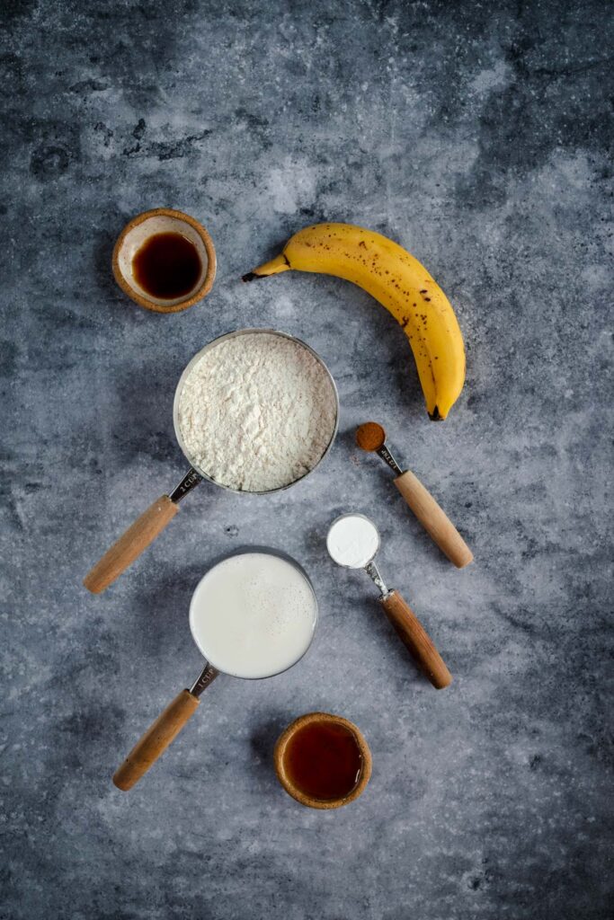 Ingredients for baking arranged neatly on a textured gray surface.