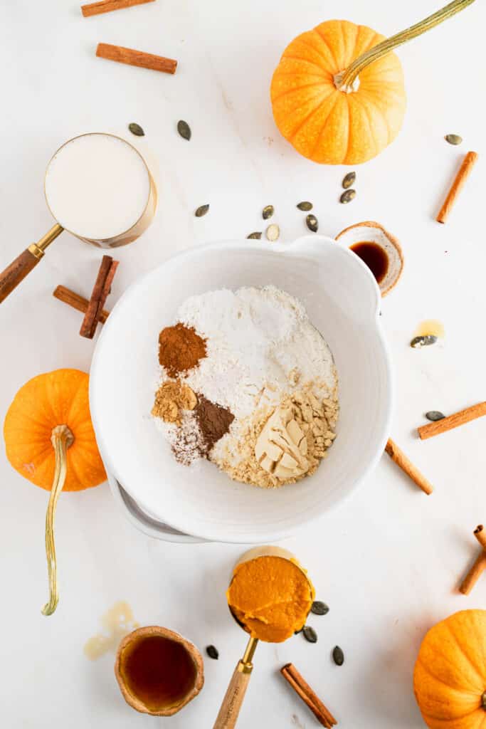 Dry ingredients for protein pumpkin pancakes added to a large mixing bowl.