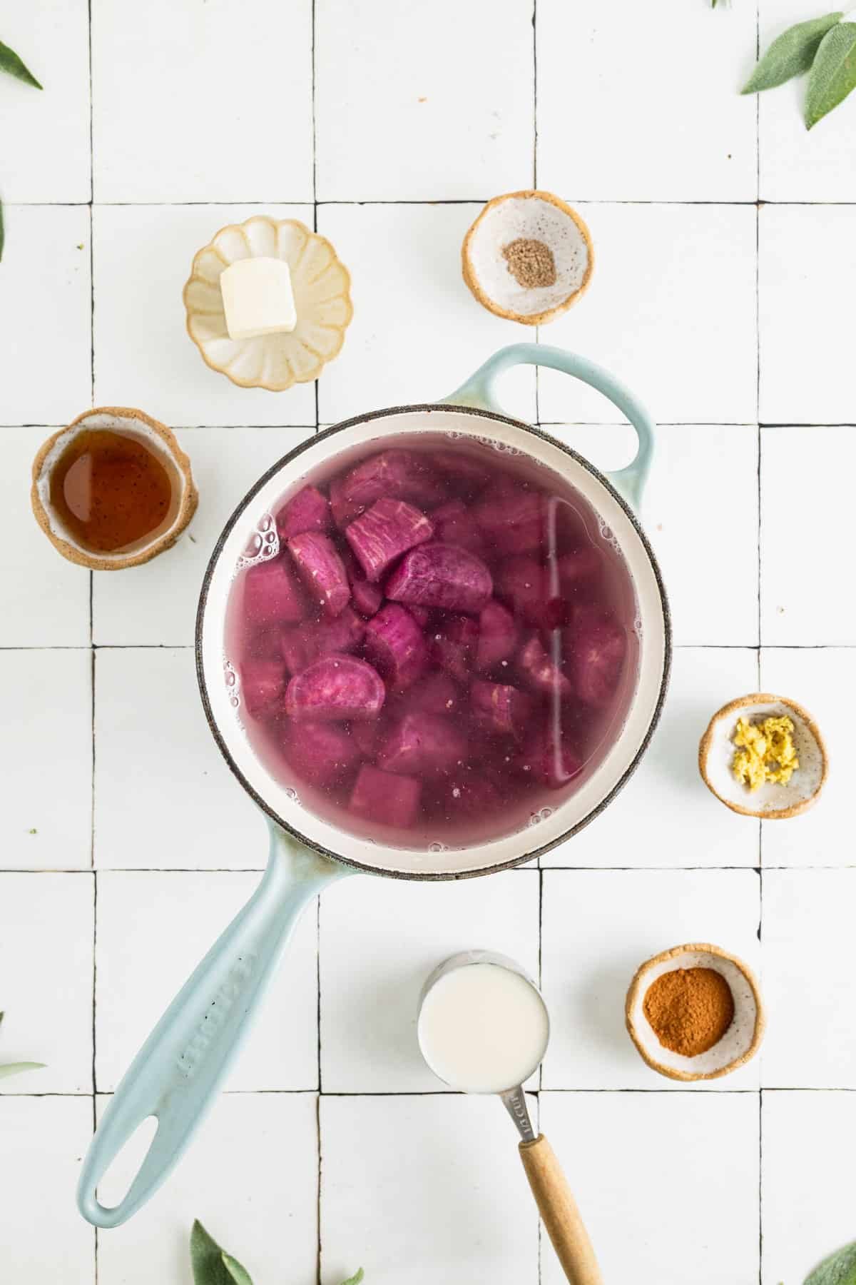 Sweet potato chunks boiling in a pot of water.