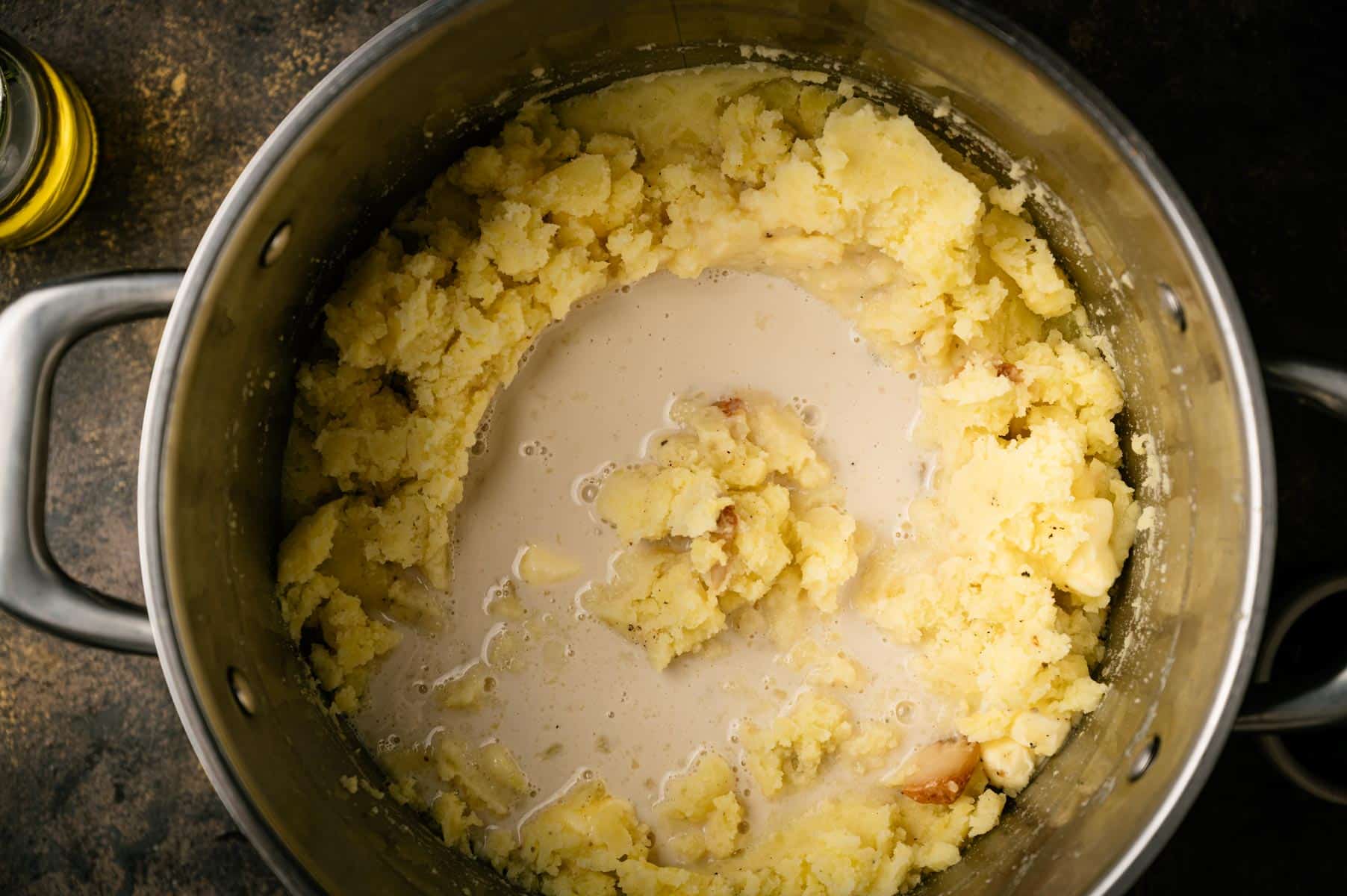 Almond milk added to the pot of mashed potatoes.