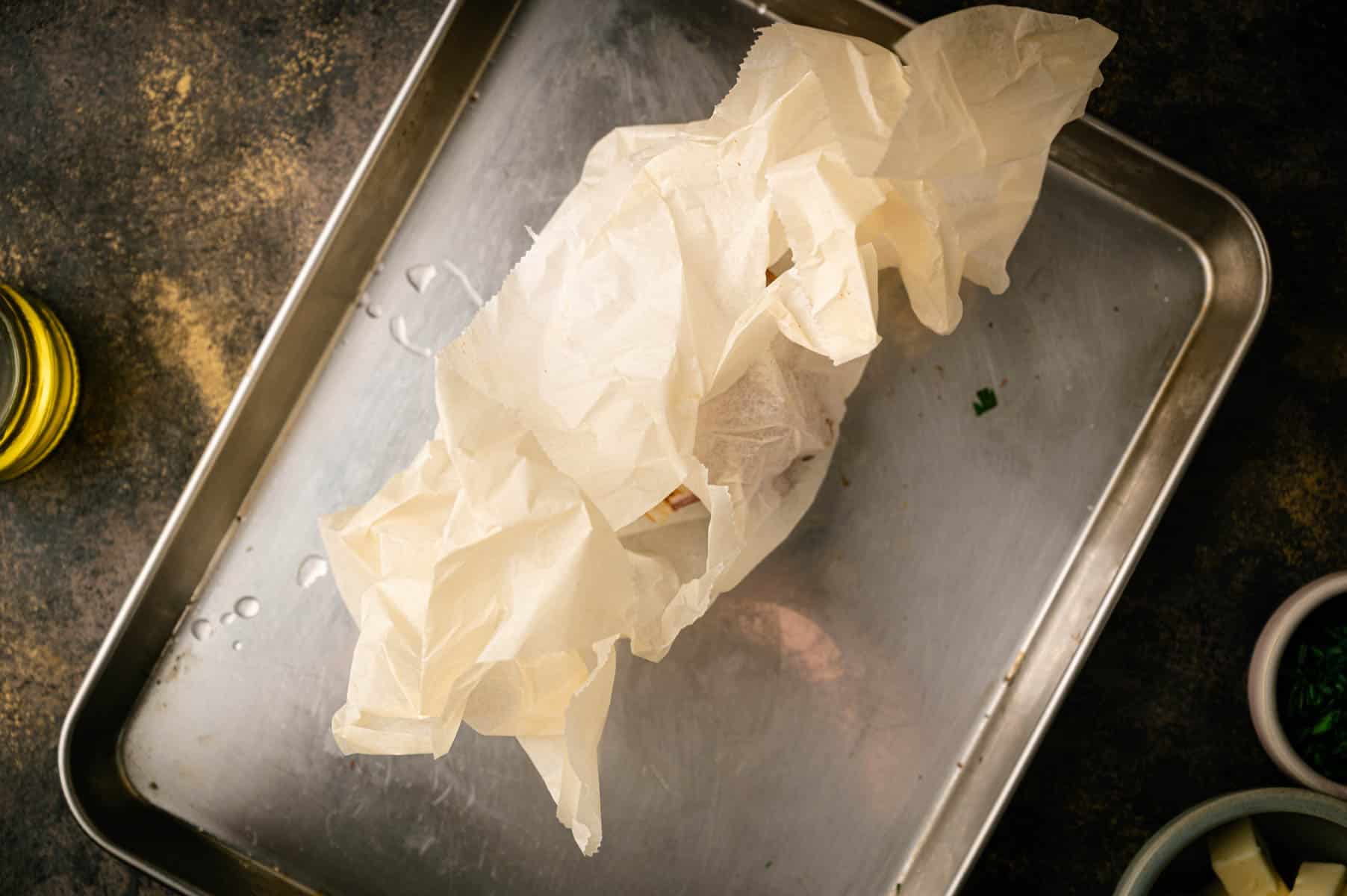 Roasting garlic in parchment paper.