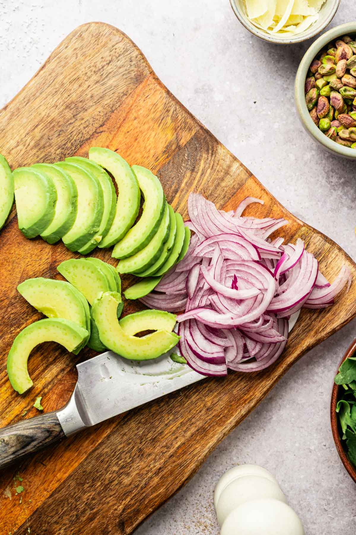 Chopping ingredients on a wooden cutting board.