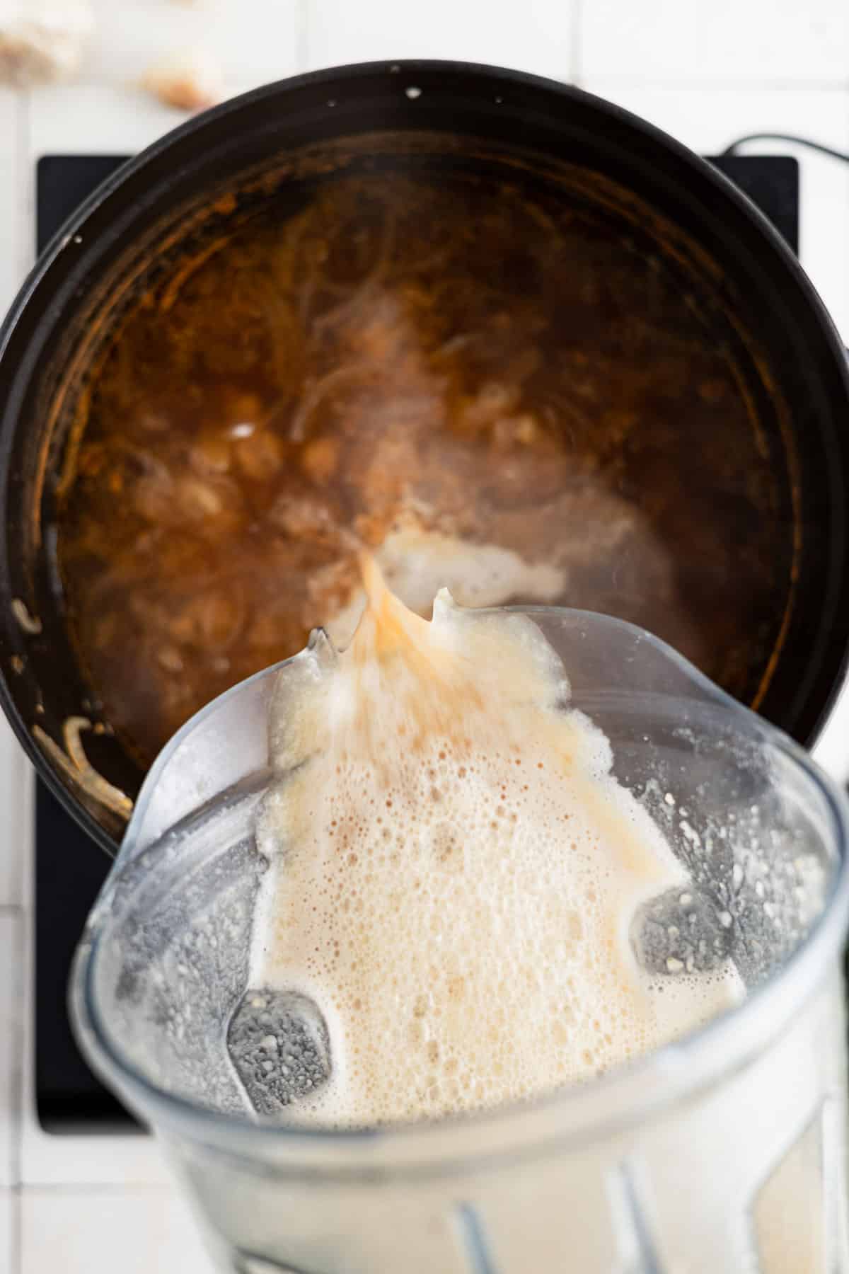Pureed soup poured into soup pot.