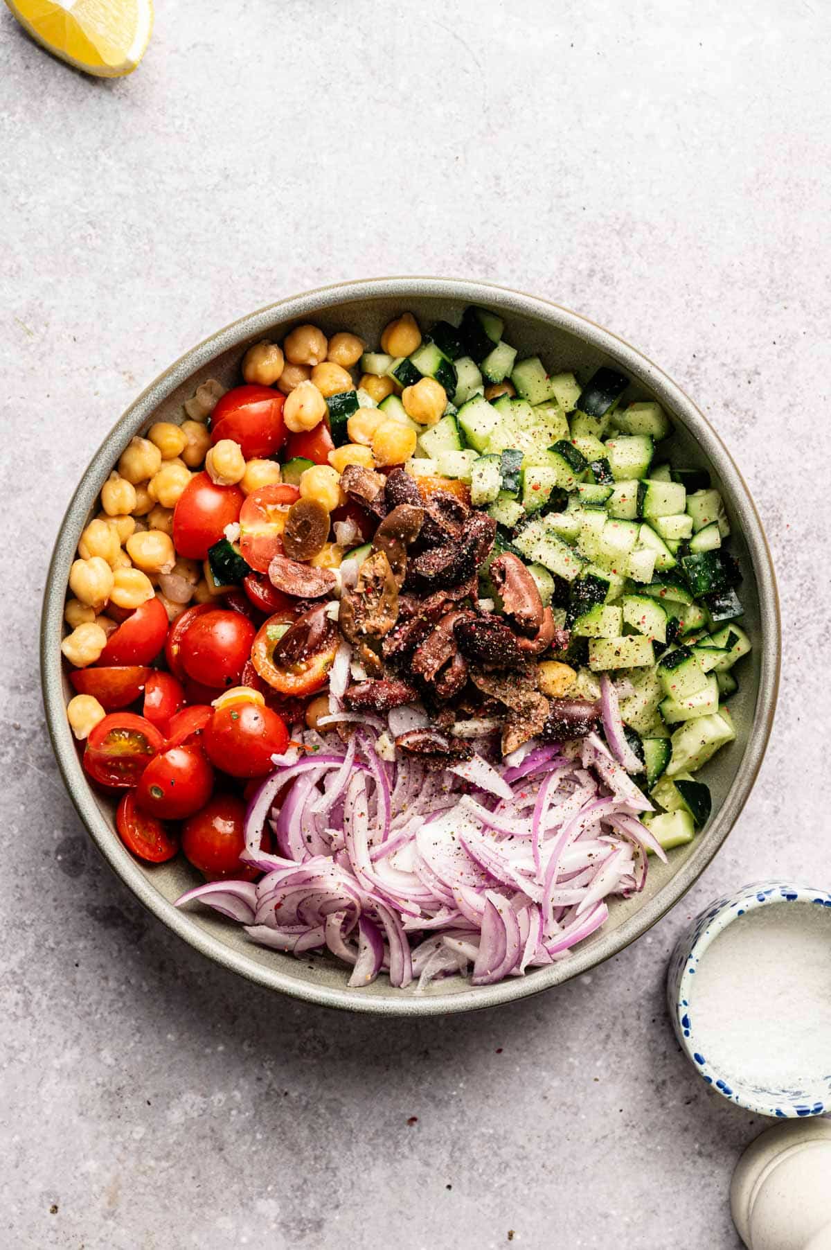 Ingredients for loaded hummus dip in a shallow bowl.