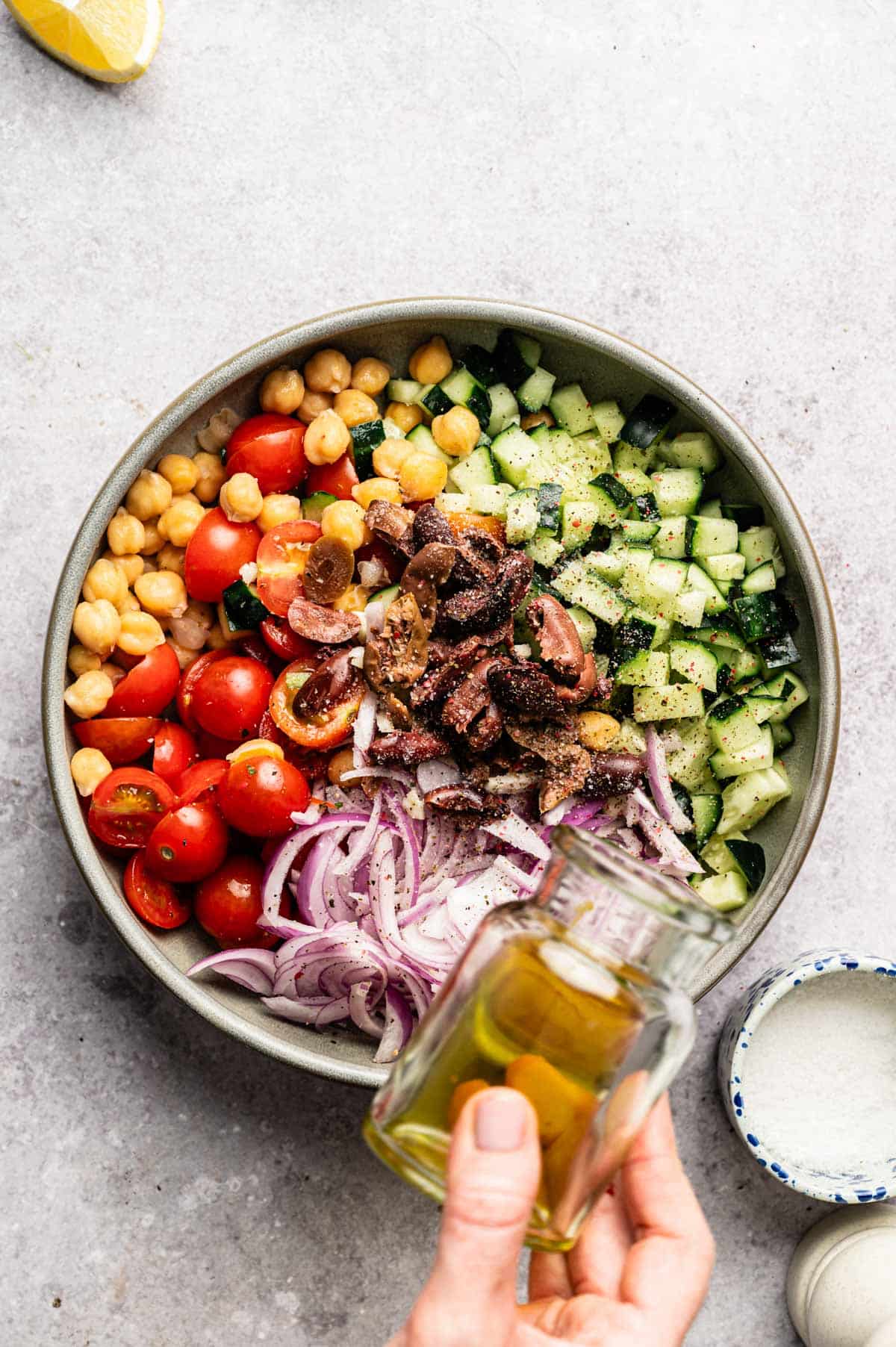 Ingredients for loaded hummus dip in a shallow bowl.