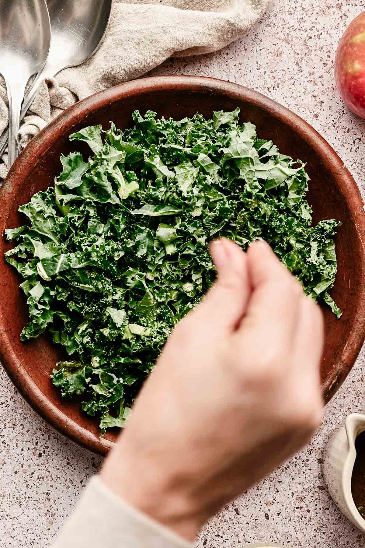 Sprinkling salt on kale.