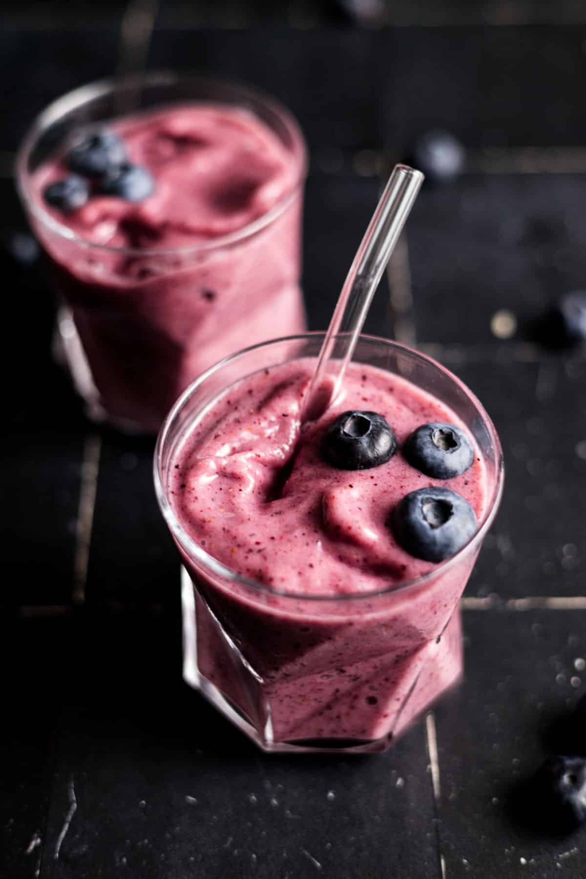 Two cups of blueberry and strawberry banana smoothie.