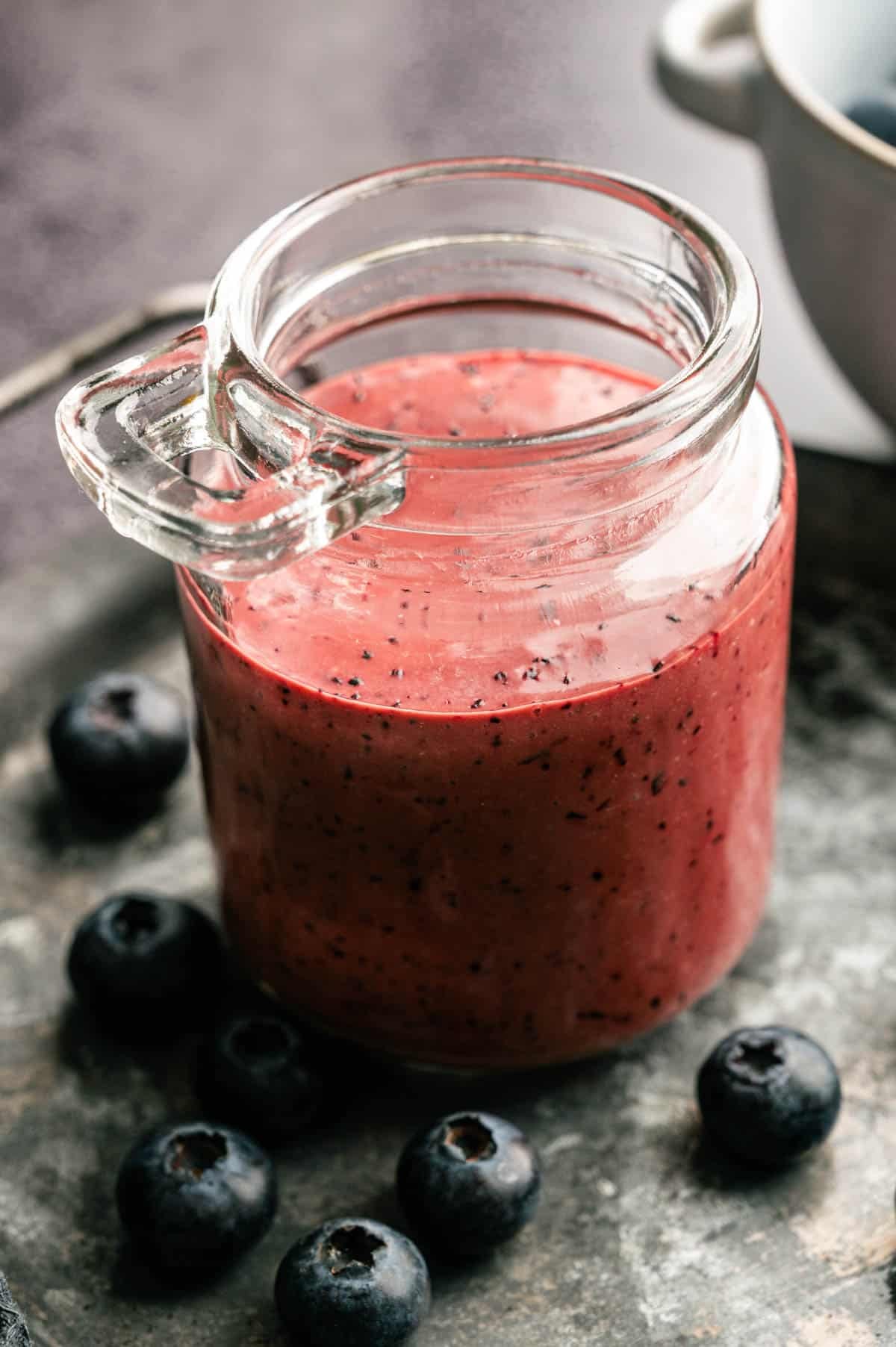 Homemade blueberry vinaigrette in a glass jar.