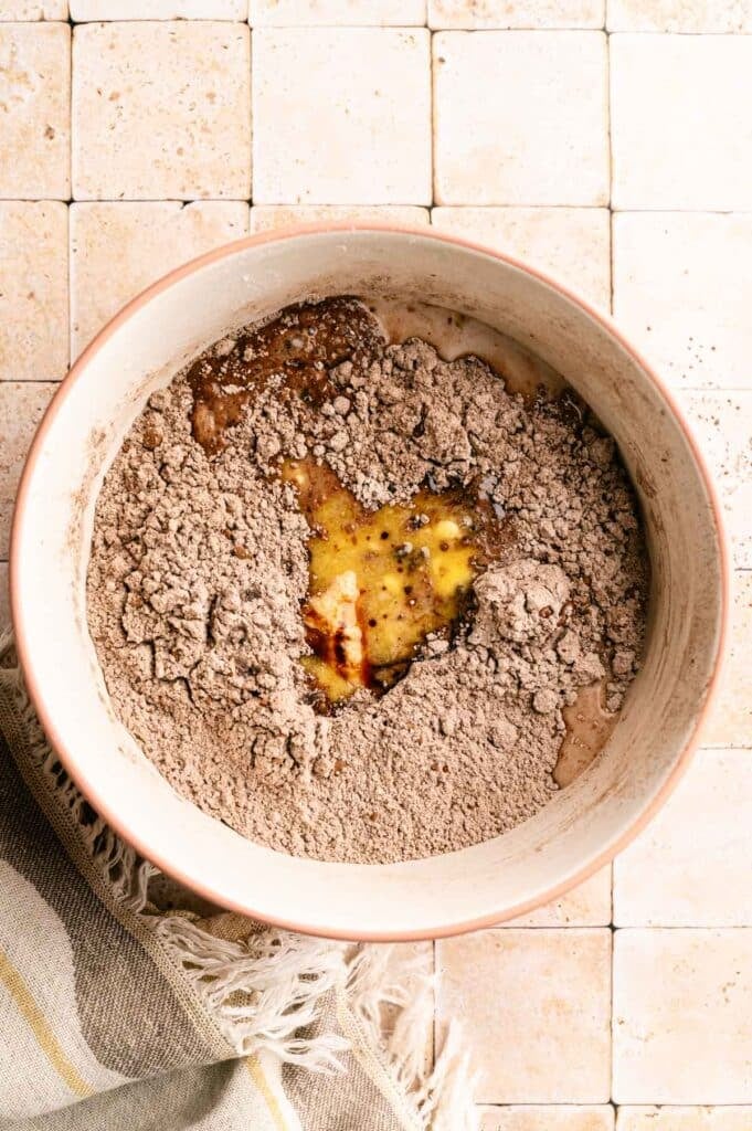 Wet ingredients added into dry ingredients for muffins.