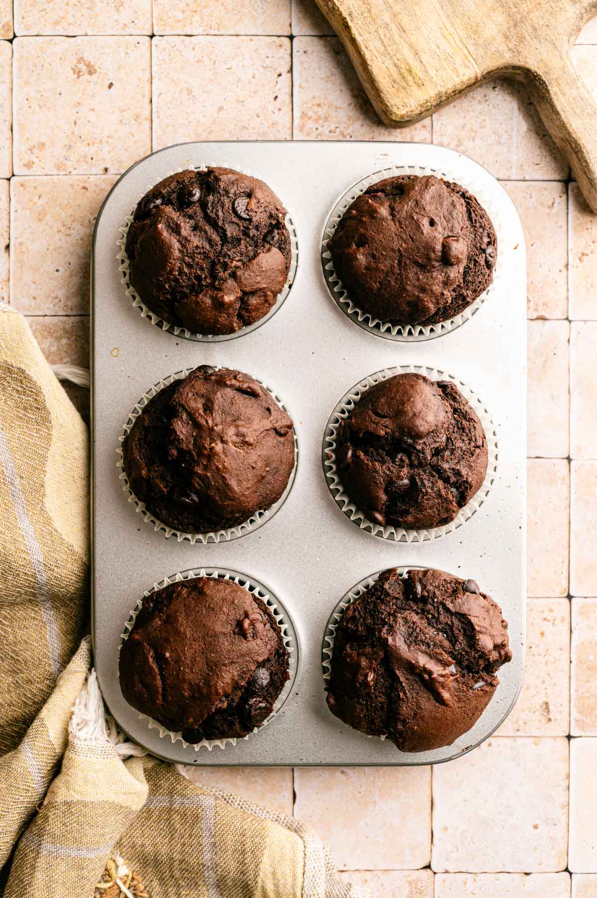 Baked extra chocolate muffins in a baking tin.