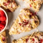 Close up of vegan raspberry scones with homemade lemon glaze.