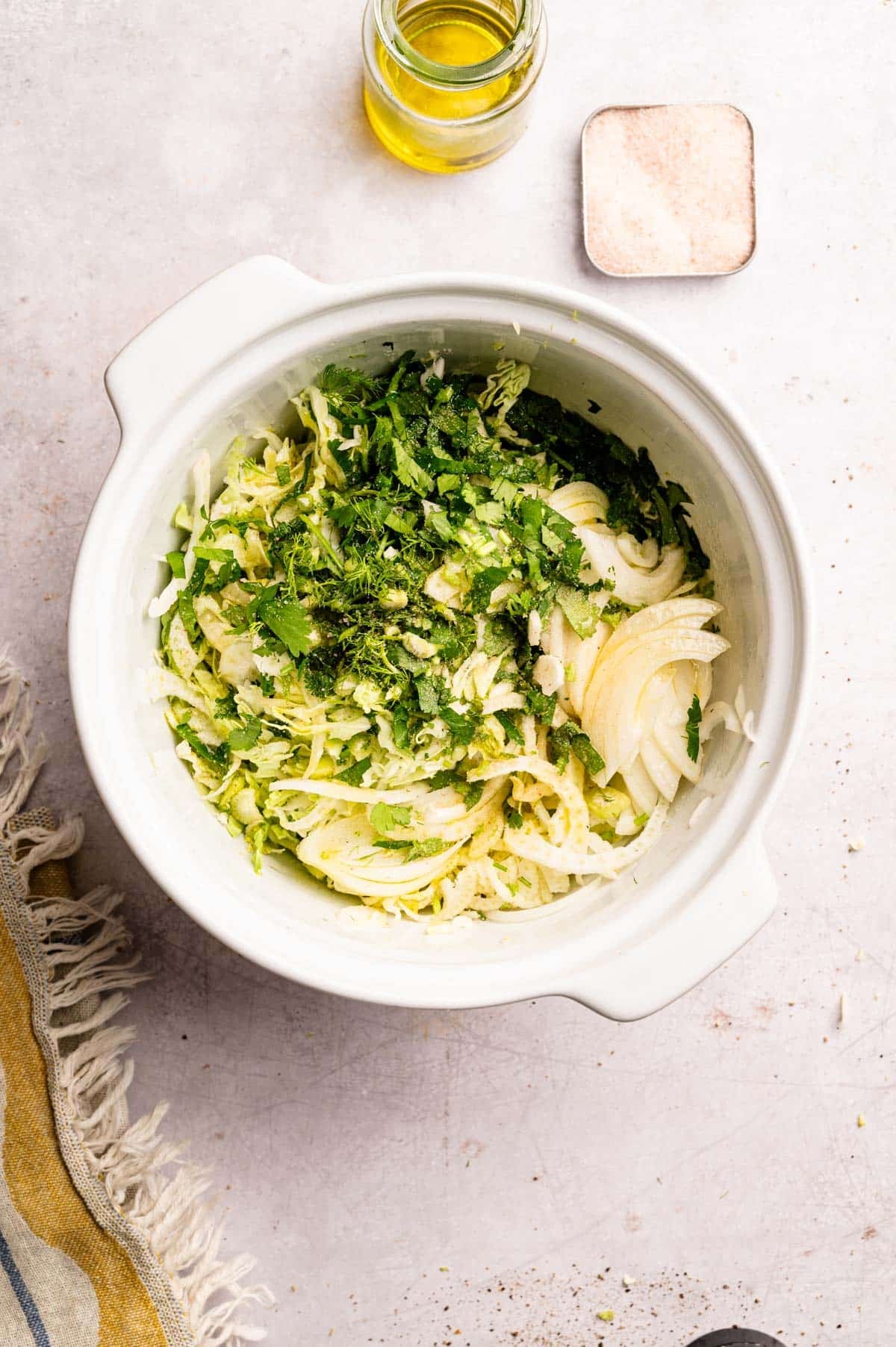 All the ingredients for shredded cabbage salad in a white mixing bowl.