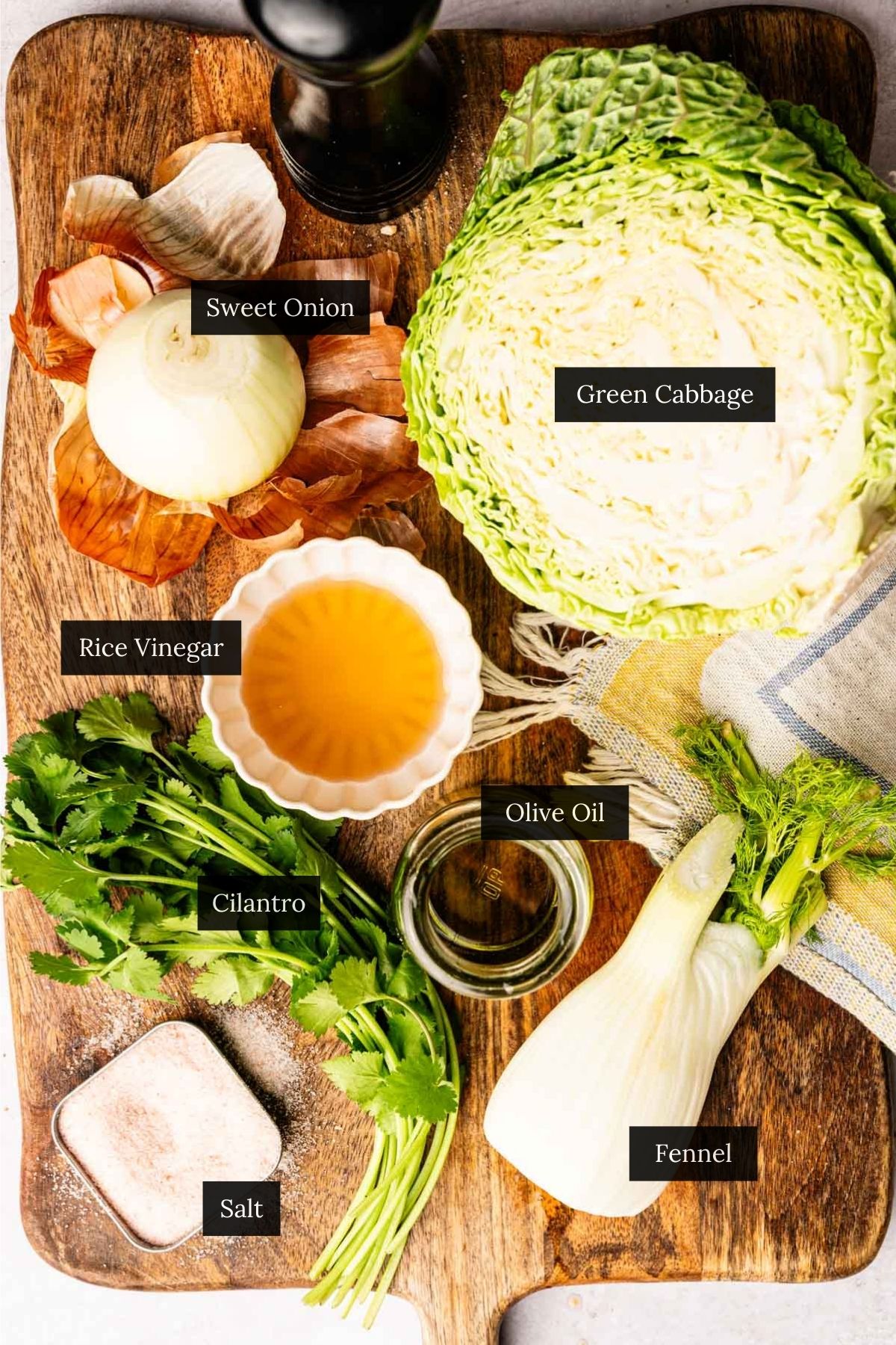 Ingredients for crunchy vegan green cabbage salad with each ingredient labeled.