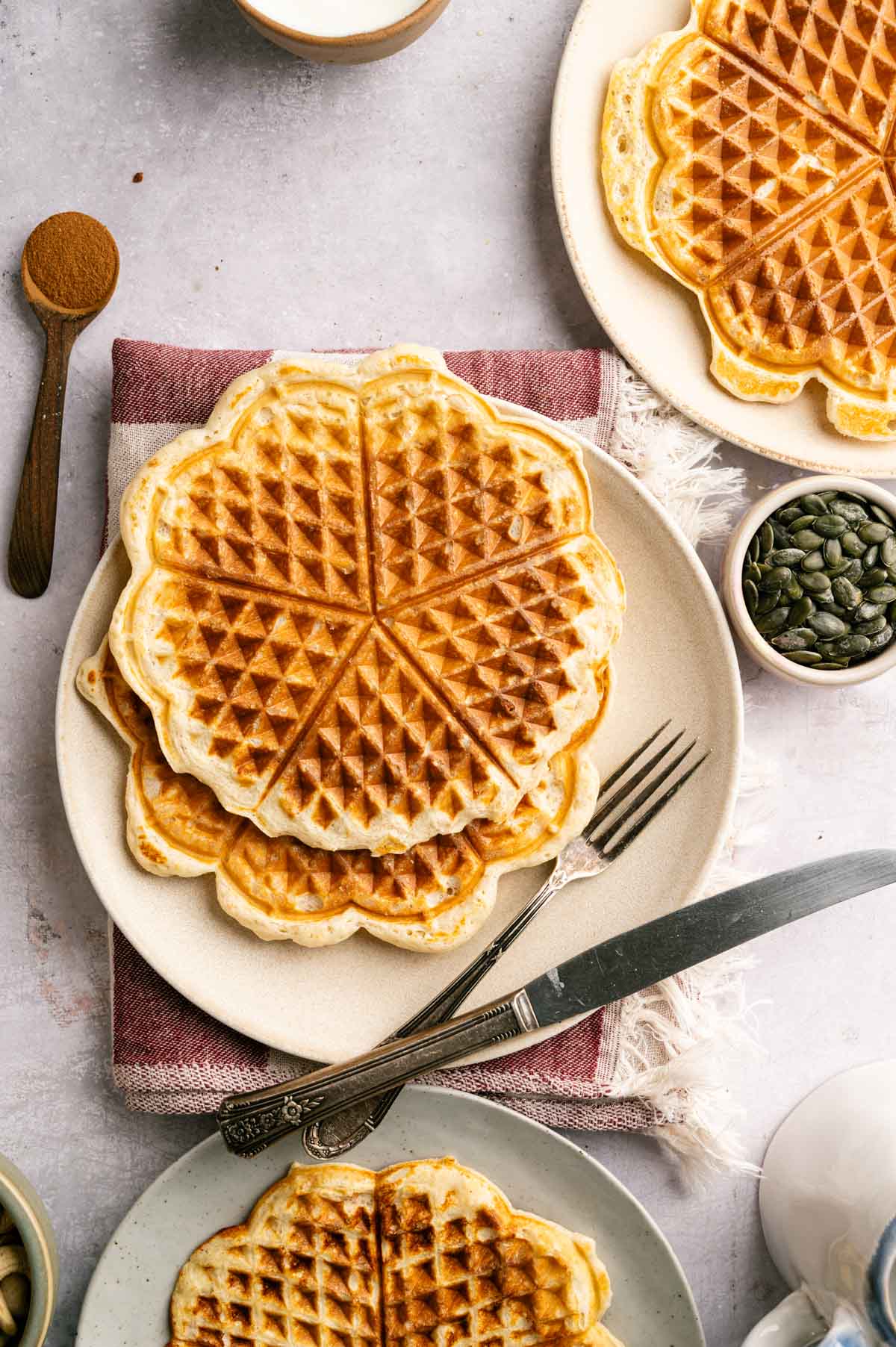 Protein powder waffles on a plate with cutlery.