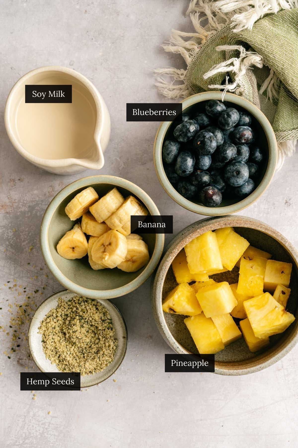 Ingredients for pineapple, banana, and blueberry smoothie.
